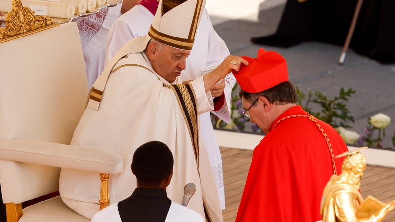 Pope Francis places a red biretta on the head of new Cardinal Christophe Pierre, nuncio to the United States, during a consistory for the creation of 21 new cardinals in St. Peter's Square at the Vatican Sept. 30, 2023. (CNS/Lola Gomez)