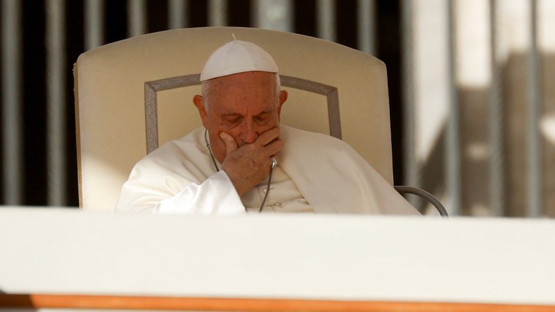 Pope Francis places his hand on his face during his weekly general audience in St. Peter's Square at the Vatican Oct. 11, 2023. (CNS/Lola Gomez)