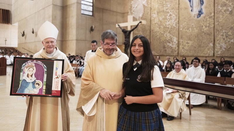 Liliana Espinoza, a 7th grader at St. Gregory the Great School in Whittier, was recognized at the Oct. 17 Missionary Childhood Association Mass as a national finalist in last year’s MCA Christmas Artwork Contest. She was presented with a framed print of her artwork by Msgr. Terrance Fleming, executive director of the LA archdiocese’s Mission Office, and Auxiliary Bishop Matthew Elshoff, who celebrated the Mass. The original art piece will be on display at the National Shrine of the Immaculate Conception in Washington D.C. during Advent 2023. (Victor Alemán)