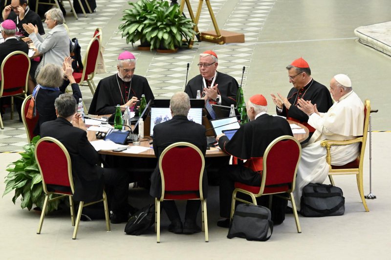 Pope Francis and leaders of the assembly of the Synod of Bishops applaud at the conclusion of the gathering's last working session Oct. 28, 2023, in the Paul VI Hall at the Vatican. (CNS/Vatican Media)