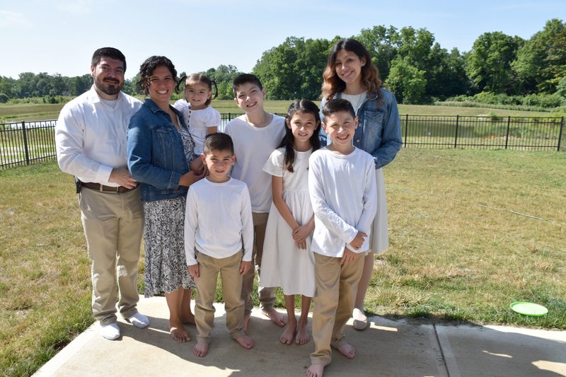 The Cabrera family poses outside of their home in Camby, Indiana. They are, from left, Daniel, Maria, Fatima Lucia, Joseph, Daniel, Gianna, David, and Sarah. (OSV/Natalie Hoefer, The Criterion)