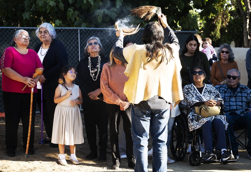 Members of the Gabrieleño San Gabriel Band of Mission Indians perform a blessing during a dedication for a new Native garden space and fountain at Mission San Gabriel Arcángel on Nov. 19. (Victor Alemán)