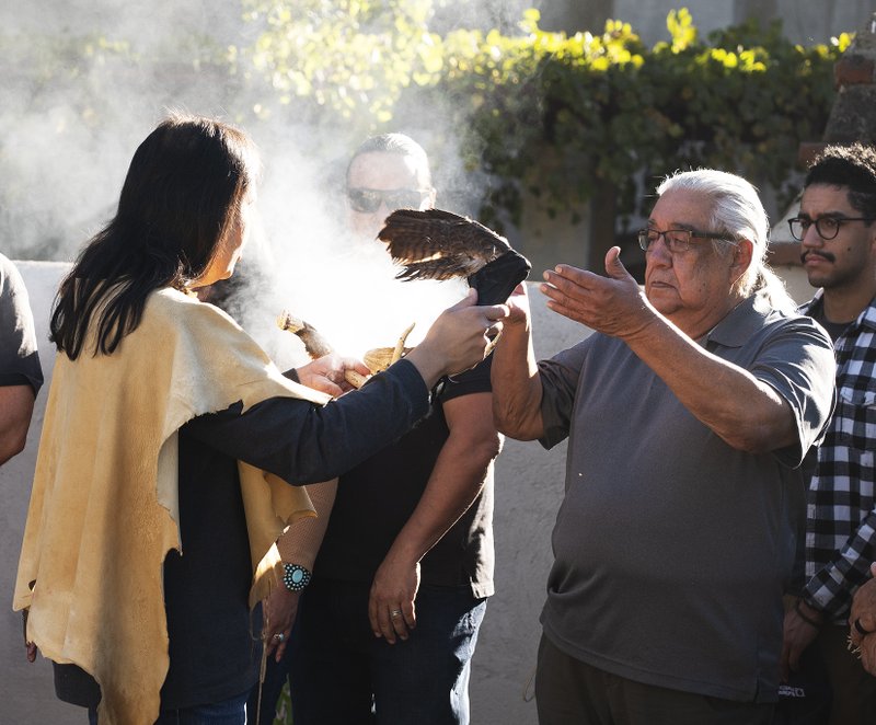 Members of the Gabrieleño San Gabriel Band of Mission Indians perform a blessing during a dedication for a new Native garden space and fountain at Mission San Gabriel Arcángel on Nov. 19. (Victor Alemán)
