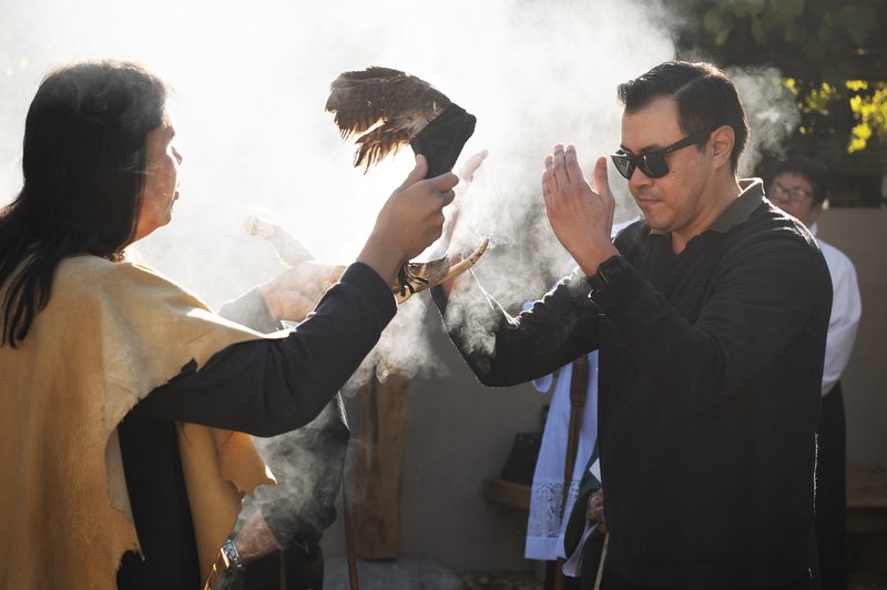 Members of the Gabrieleño San Gabriel Band of Mission Indians perform a blessing during a dedication for a new Native garden space and fountain at Mission San Gabriel Arcángel on Nov. 19. (Victor Alemán)