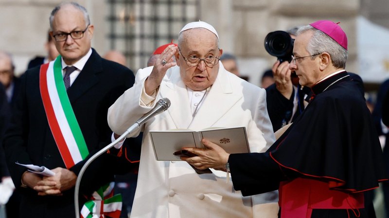Pope Francis gives his blessing in front of a Marian statue near the Spanish Steps in Rome on Dec. 8, the feast of the Immaculate Conception. Roberto Gualtieri, the mayor of Rome, is at the left. (CNS/Lola Gomez)