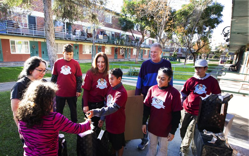 Volunteers drop off gifts for families on Dec. 16 as part of the Archdiocese of Los Angeles’ Adopt-a-Family program that began in 1990. (Victor Alemán)