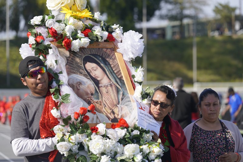 Participants walk with decorated floats during the 92nd Procession and Mass honoring Our Lady of Guadalupe and St. Juan Diego at East LA College Stadium on Dec. 3. (Sarah Yaklic)
