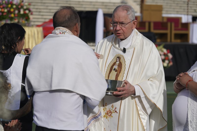 Los Angeles Archbishop José H. Gomez offers holy Communion to those attending the 92nd Procession and Mass honoring Our Lady of Guadalupe and St. Juan Diego at East LA College Stadium on Dec. 3. (Sarah Yaklic)