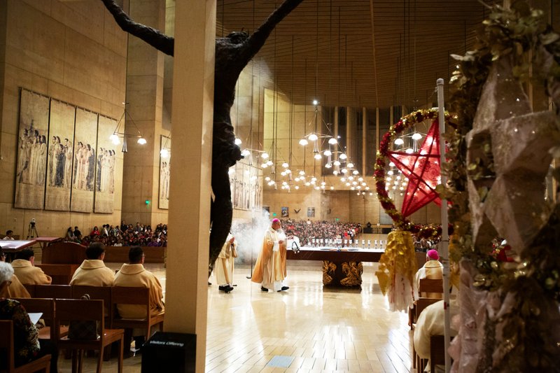 Archbishop Jose H. Gomez dispenses incense during the annual Simbang Gabi kickoff Mass Dec. 15 at the Cathedral of Our Lady of the Angels. (Victor Alemán)