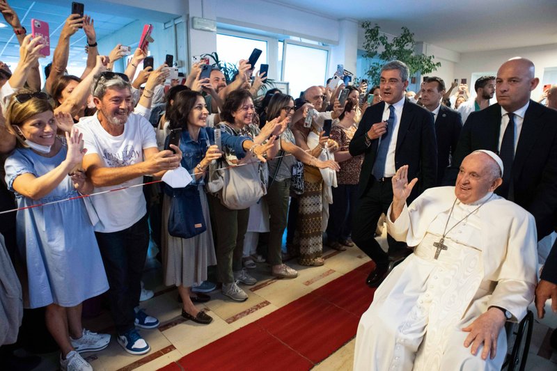 Pope Francis smiles and waves to people as he leaves Rome's Gemelli hospital early June 16, 2023, nine days after undergoing abdominal surgery. (CNS/Vatican Media)