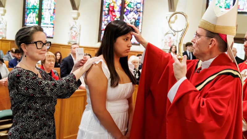 Boston Auxiliary Bishop Robert P. Reed administers the sacrament of confirmation to a young woman at St. Bridget Church in Framingham, Mass., March 11, 2023. (OSV News/Gregory L. Tracy, The Pilot)