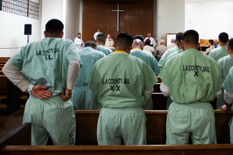 Inmates at Men’s Central Jail in Los Angeles stand during the Gospel at Christmas Mass the morning of Dec. 25. (Victor Alemán)