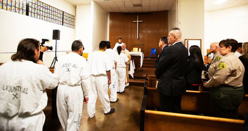 Los Angeles Archbishop José H. Gomez offers Communion to inmates at Men’s Central Jail in Los Angeles while celebrating Christmas Mass the morning of Dec. 25. (Victor Alemán)