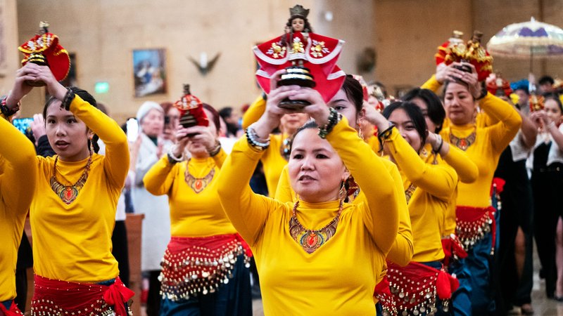 A parade of colorful parishioners hold up their statues during the Feast of Santo Niño Mass at the Cathedral of Our Lady of the Angels on Jan. 21. (Victor Alemán)