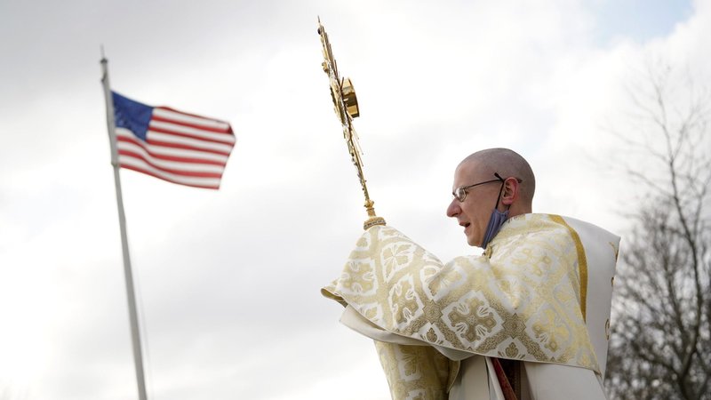 Father Liam McDonald, pastor of St. Therese of Lisieux Church in Montauk, N.Y., holds a monstrance containing the Blessed Sacrament as he leads a Eucharistic procession in Montauk in observance of Religious Freedom Day Jan. 16, 2022. (OSV News/CNS file, Gregory A. Shemitz)