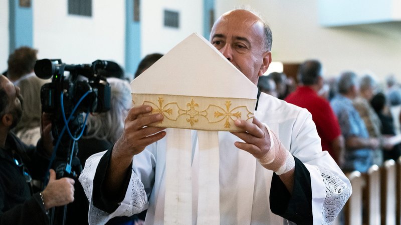 A miter belonging to late Auxiliary Bishop David O’Connell is brought forward at the start of a Feb. 24 memorial Mass at Mission San Gabriel marking a year since his death. (Victor Alemán)