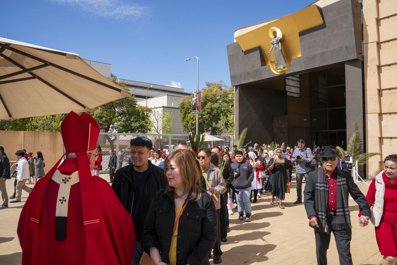 Archbishop José H. Gomez greets parishioners following the Palm Sunday Mass on March 24. (John Rueda)