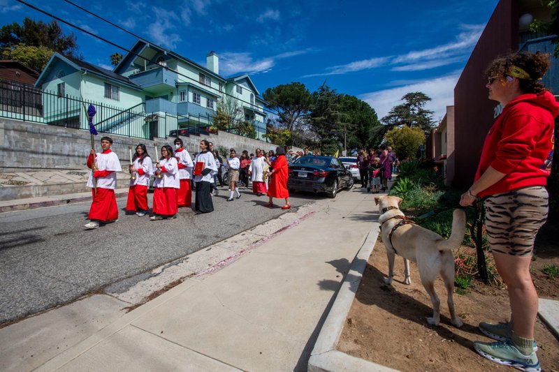 Altar servers lead the way in St. Teresa of Avila Church’s Palm Sunday procession through the streets of Silver Lake on March 24. (Mike Goulding)