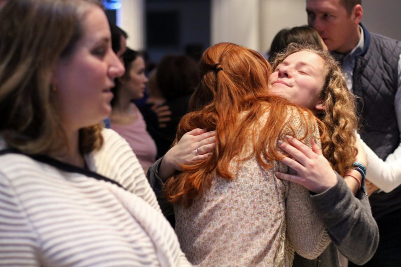 Women embrace at the sign of peace during Mass Jan. 15, 2017, at the New York Encounter in New York City. (CNS/Gregory A. Shemitz)