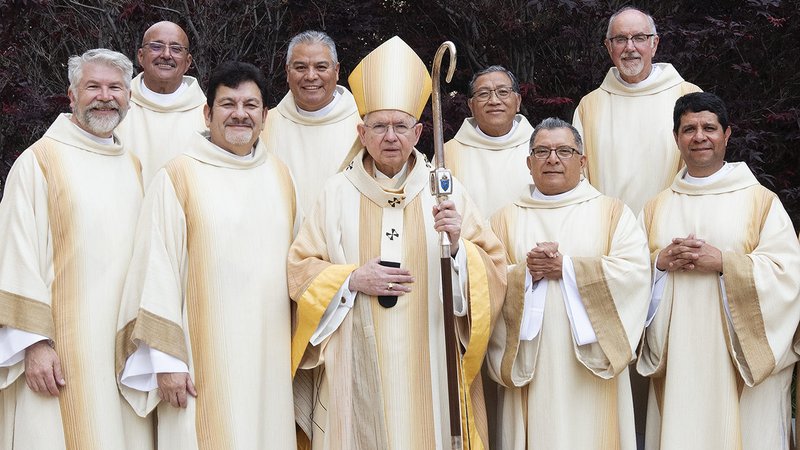 The eight deacons pose with Archbishop José H. Gomez following their ordination Mass at the Cathedral of Our Lady of the Angels on June 8. (Victor Alemán)