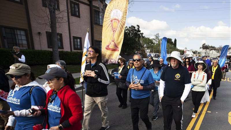 Hundreds of parishioners walked with the Blessed Sacrament during a six-mile Eucharistic procession, led by Archbishop José H. Gomez, on March 25. The local event was planned as part of the National Eucharistic Revival. (Victor Alemán)