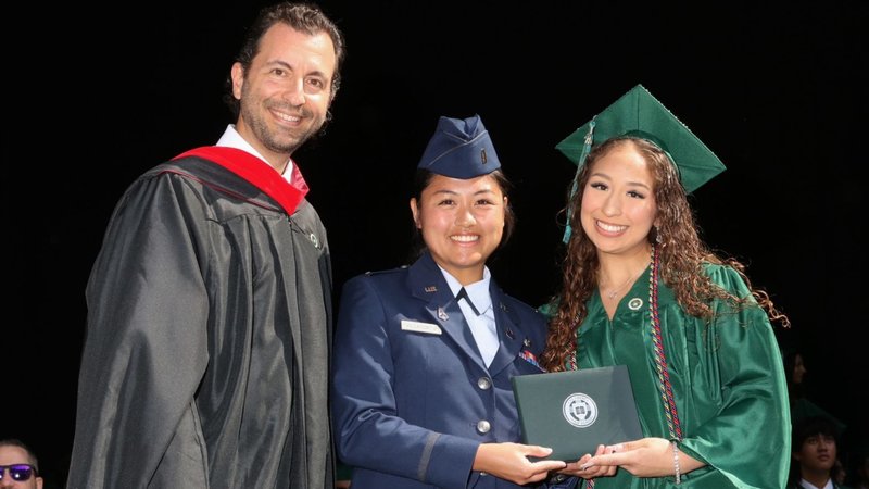 Thalia Cintron, right, poses with Scott McLarty, left, Providence High’s Head of School, and Air Force Lt. Kyle Villacorta after graduating on June 1. (Submitted photo)