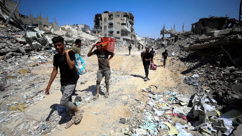 Palestinians make their way through the Shejaiya neighborhood in the eastern part of Gaza City July 10, 2024, inspecting the damage after Israeli forces withdrew following a ground operation amid the ongoing Israel-Hamas conflict. (OSV News photo/Dawoud Abu Alkas, Reuters)
