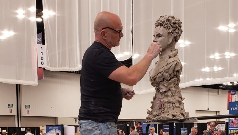 Timothy Schmalz works on a model for a sculpture he is creating of Blessed Carlo Acutis July 18, 2024, during the National Eucharistic Congress. (OSV News photo/Natalie Hoefer, The Criterion)