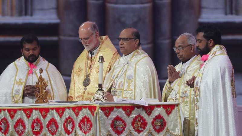 Syro-Malabar Bishop Joy Alappatt, center, and Metropolitan Archbishop Borys A. Gudziak of the Ukrainian Catholic Archeparchy of Philadelphia, in gold vestments, concelebrate Holy Qurbana July 20, 2024, in Lucas Oil Stadium in Indianapolis during the National Eucharistic Congress. Holy Qurbana is the name for Mass in the Catholic Church's Syro-Malabar rite. (OSV News photo/Bob Roller)