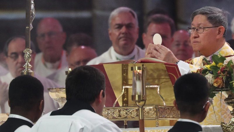 Cardinal Luis Antonio Tagle, pro-prefect of the Dicastery for Evangelization’s Section for First Evangelization and New Particular Churches, raises the host July 21, 2024, during the final Mass of the National Eucharistic Congress at Lucas Oil Stadium in Indianapolis. (OSV News photo/Bob Roller)
