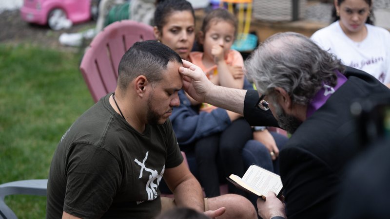 Alex Hernandez from the Diocese of Allentown receives the sacrament of anointing of the sick from Father Brendon LaRoche while surrounded by his family in a scene from the July 2024 Pope Video. (Isabel Cacho)