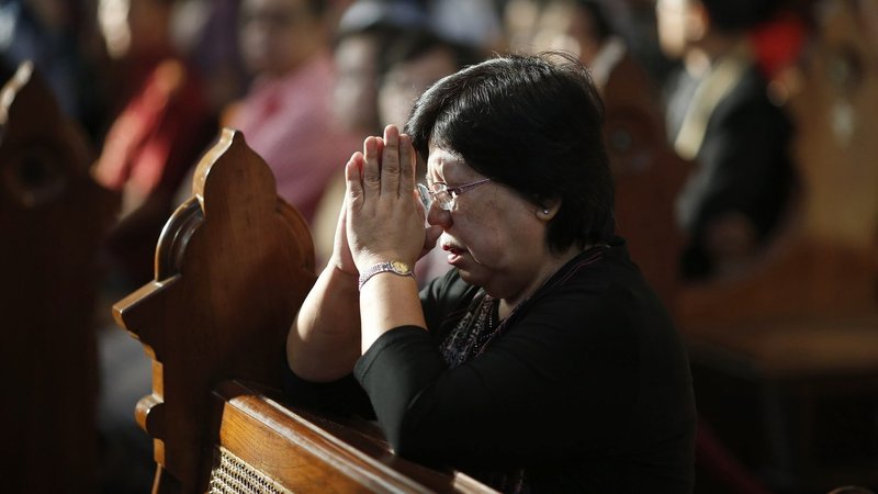A woman prays during Christmas Mass at the cathedral in Jakarta, Indonesia. (CNS/Darren Whiteside, Reuters)
