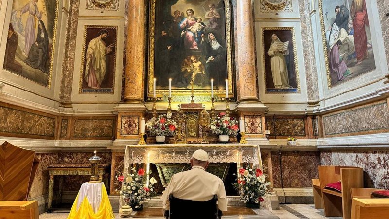 Pope Francis stops to pray before the tomb of St. Monica in the Rome basilica named for her son, St. Augustine, on the feast of St. Monica, Aug. 27, 2024. (CNS photo/Vatican press office)