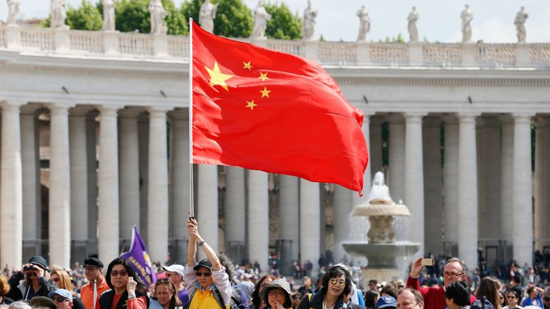 In this file photo, a visitor waves China's flag as Pope Francis leads his general audience in St. Peter's Square at the Vatican May 22, 2019. (CNS photo/Paul Haring)