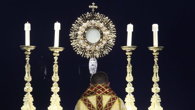 Bishop Andrew H. Cozzens of Crookston, Minn., chairman of the board of the National Eucharistic Congress, Inc., kneels in prayer before the monstrance during Eucharistic adoration at the opening revival night July 17, 2024, of the 10th National Eucharistic Congress at Lucas Oil Stadium in Indianapolis. The National Eucharistic Congress Inc. announced Sept. 3, 2024, the launch of the Society of the Eucharistic Heart of Jesus to boost efforts of the National Eucharistic Revival. (OSV News photo/Bob Roller)