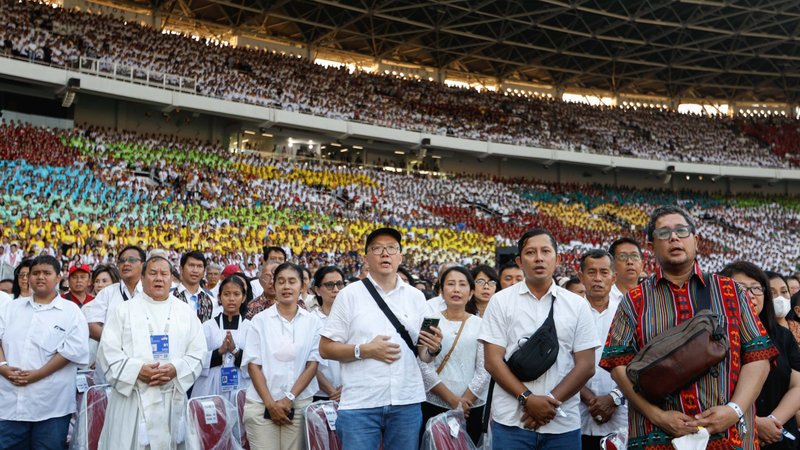People pray as Pope Francis celebrates Mass at Gelora Bung Karno Stadium in Jakarta, Indonesia, Sept. 5, 2024. (CNS photo/Lola Gomez)