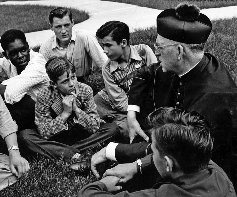 Father Edward Flanagan, the Irish-born priest who founded Boys Town in Nebraska, talks with a group of boys in this undated photo. (OSV News/courtesy Boys Town)