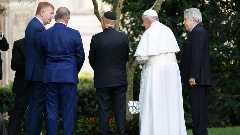 Pope Francis stands with Raphael Schutz, the Israeli ambassador to the Holy See, Issa Kassissieh, Palestinian ambassador to the Holy See, and representatives of Rome's Jewish and Muslim communities by an olive tree in the Vatican Gardens in this June 7, 2024 file photo. (CNS photo/Lola Gomez)