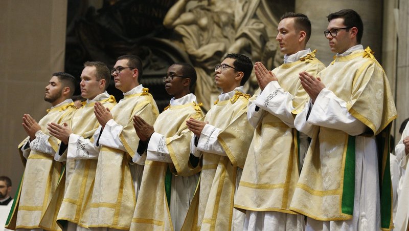 Newly ordained deacons pray during their ordination Mass in St. Peter's Basilica at the Vatican Oct. 3, 2024. (CNS photo/Justin Mclellan)