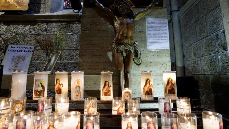 A crucifix and candles are pictured in Notre-Dame Basilica in Nice, France, Oct. 4, 2021. A report on clergy sexual abuse in the Catholic Church in France, published Oct. 5, 2021, showed there have been 3,000 abusers since the 1950s. (CNS photo/Eric Gaillard, Reuters)