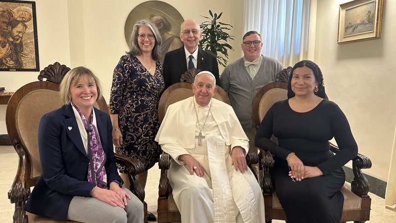 Pope Francis poses for a photo with a delegation from New Ways Ministry, including transgender and intersex Catholics, during a meeting at his residence at the Vatican Oct. 12, 2024. Pictured from left are Cynthia Herrick, Laurie Dever, Deacon Ray Dever, Michael Sennett and Nicole Santamaria. (CNS photo/courtesy New Ways Ministry)