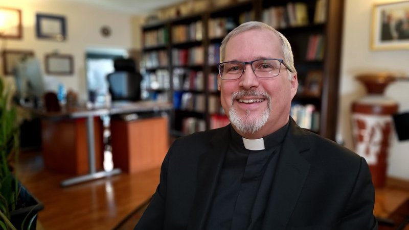 Father Philip Larrey last year in his apartment in Rome, where he was dean of the philosophy department at the Pontifical Lateran University. Today, Larrey teaches philosophy at Boston College and helps organize conferences to better understand the implications of AI. (CNS/Robert Duncan)