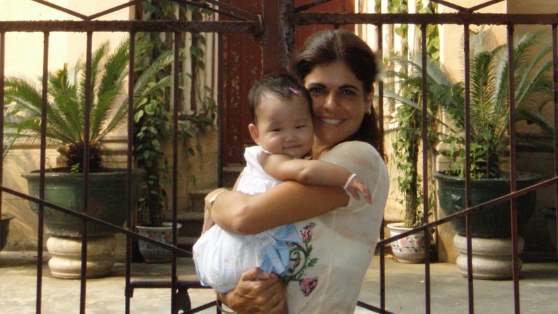 The author with her newly adopted daughter at Our Lady of Lourdes Catholic Church on Shamian Island in Guangzhou, China. (Courtesy Grazie Christie)