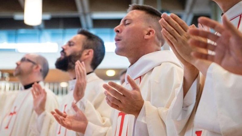Religious men are pictured in an undated photo praying. The Companions of the Cross is a religious community founded in 1985 by Father Bob Bedard. The community is a group of priests and seminarians that minister in parishes and schools across Canada and the United States with their charism of evangelization and charismatic worship. (OSV News photo/courtesy Congregation of the Cross photo) Editors: best quality available.