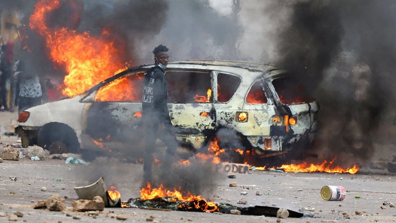 A protester stands near a burning barricade in Maputo, Mozambique, Nov. 7, 2024, during a "national shutdown" against protests over the outcome of general elections. (OSV News photo/Siphiwe Sibeko, Reuters)