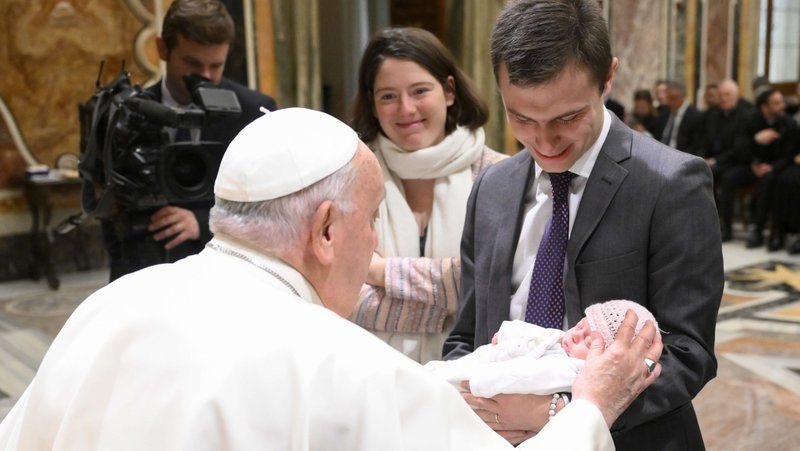 Pope Francis greets a baby and couple during a meeting with the academic community of the John Paul II Pontifical Theological Institute for Marriage and Family Sciences at the Vatican Nov. 25, 2024. (CNS photo/Vatican Media)