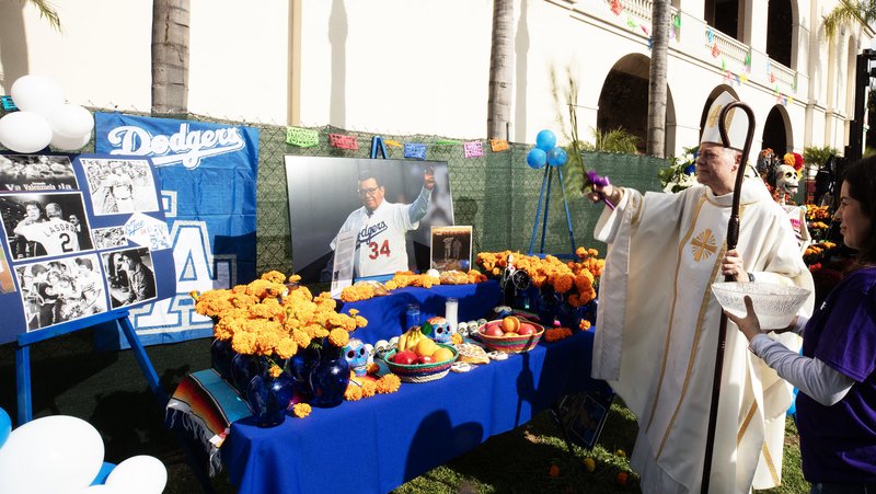 Auxiliary Bishop Matthew Elshoff blesses an altar dedicated to Dodgers pitcher Fernando Valenzuela at San Fernando Mission Cemetery on Nov. 2.