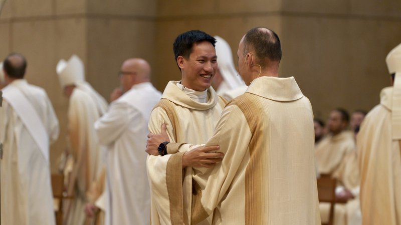 Quoc Vo receives congratulations during the transitional diaconate Ordination Mass at the Cathedral of Our Lady of the Angels on Nov. 23. (Reese Cuevas)