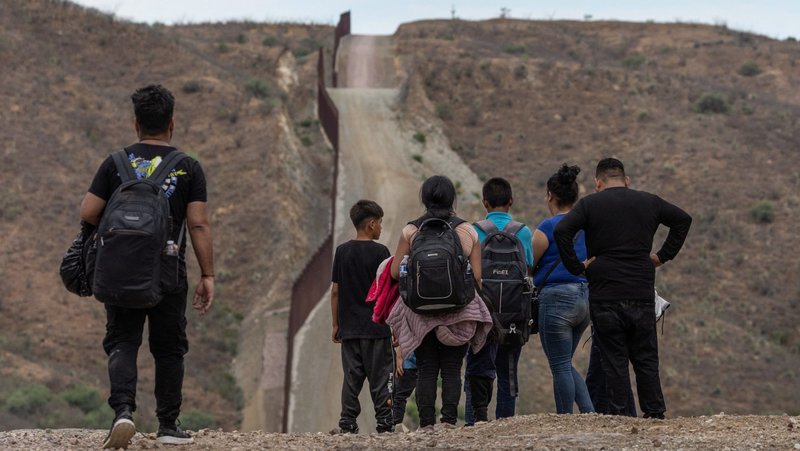 The Border Wall is seen in the background as migrants from South and Central America look to surrender to immigration officials after crossing into the United States from Mexico in Ruby, Arizona, June 24, 2024. (OSV News photo/Adrees Latif, Reuters)