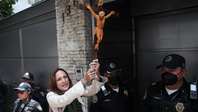 A woman holds a crucifix as she takes part in a protest outside the Nicaraguan Embassy in Mexico City Aug. 16, 2022, to demand respect for religious freedom and an end to the persecution against the church and against the opponents of the government of Nicaraguan President Daniel Ortega. (OSV News photo/Edgard Garrido, Reuters)